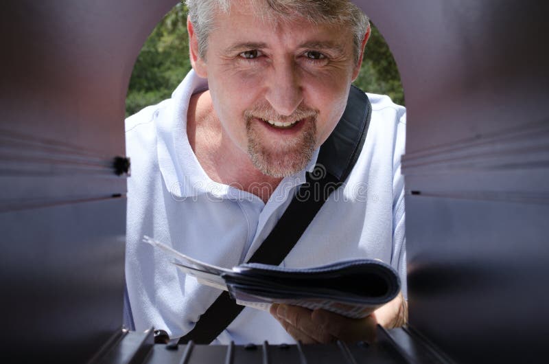 Mailman Making a Delivery of Letters To a Mailbox Stock Photo Image