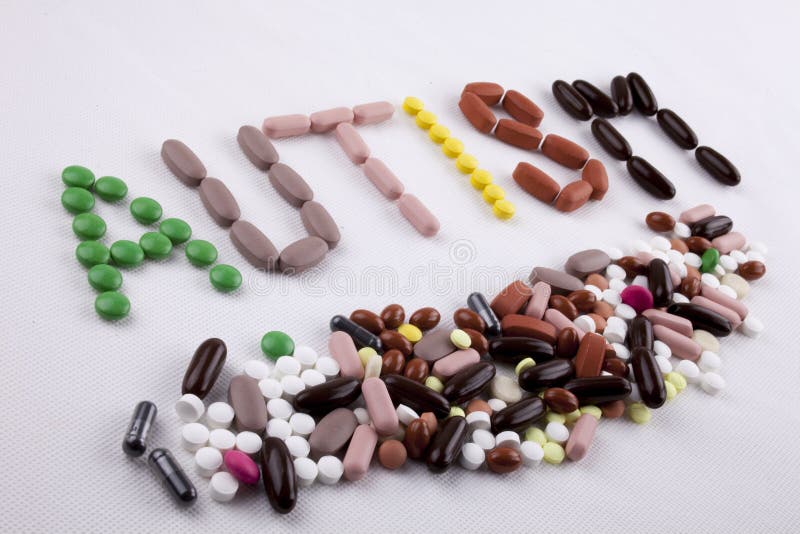 Main ?crivant le concept de soins m?dicaux d'inspiration de l?gende des textes ?crit avec le mot AUTISME de capsule de drogues de photo stock Main ?crivant le concept de soins m?dicaux d'inspiration de l?gende des textes ?crit avec le mot AUTISME de capsule de drogues de photo stock