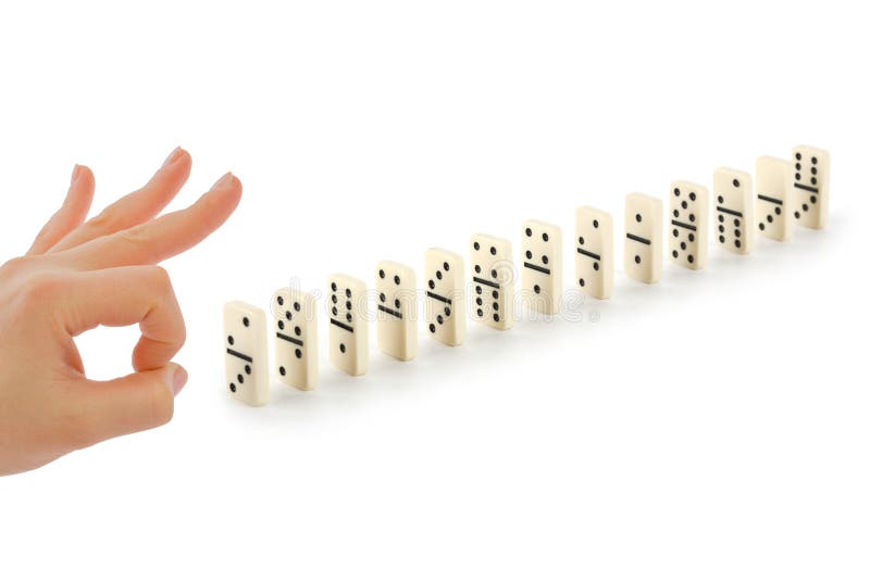 Main et domino photographie stock