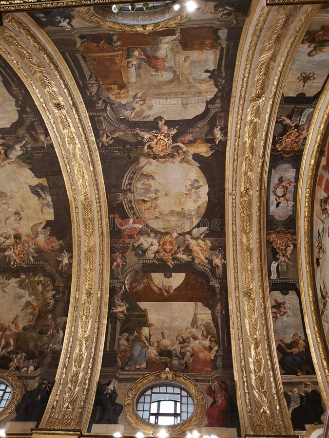 The main nave ceiling in the St John Co Cathedral, Valletta, Malta. The main nave with arched ceiling painted by Mattia Preti and gilded columns and marble floor royalty free stock images The main nave ceiling in the St John Co Cathedral, Valletta, Malta. The main nave with arched ceiling painted by Mattia Preti and gilded columns and marble floor royalty free stock images