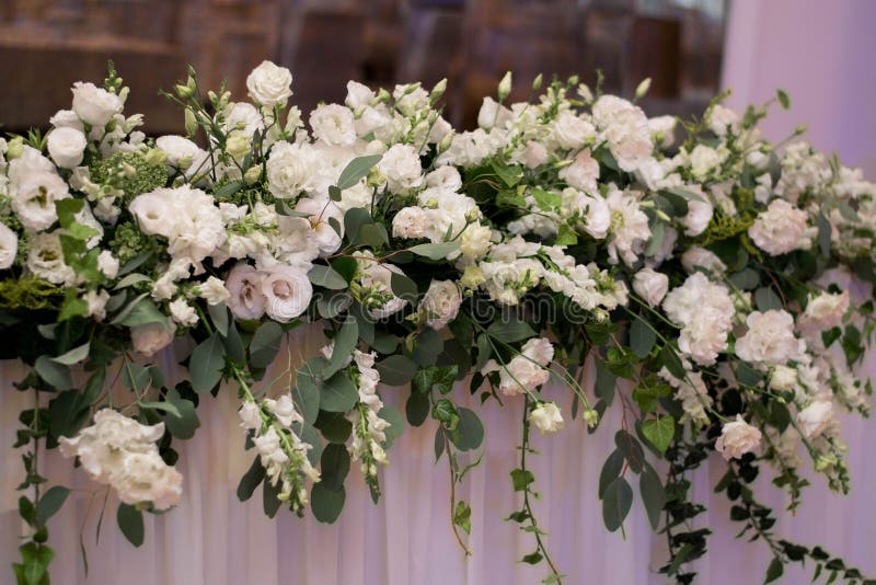 Main Table at a Wedding Reception with Beautiful Fresh Flowers Stock