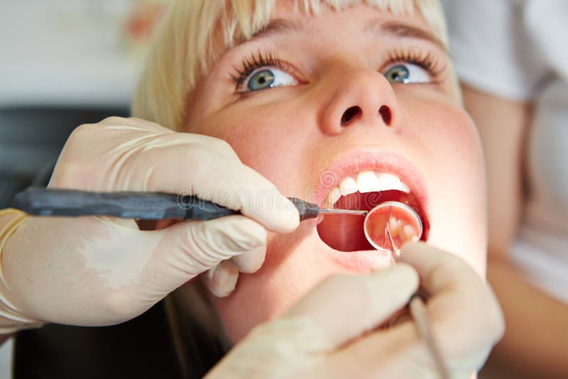 Dentiste Donnant Le Traitement Dentaire Avec La Sonde Et Le Miroir