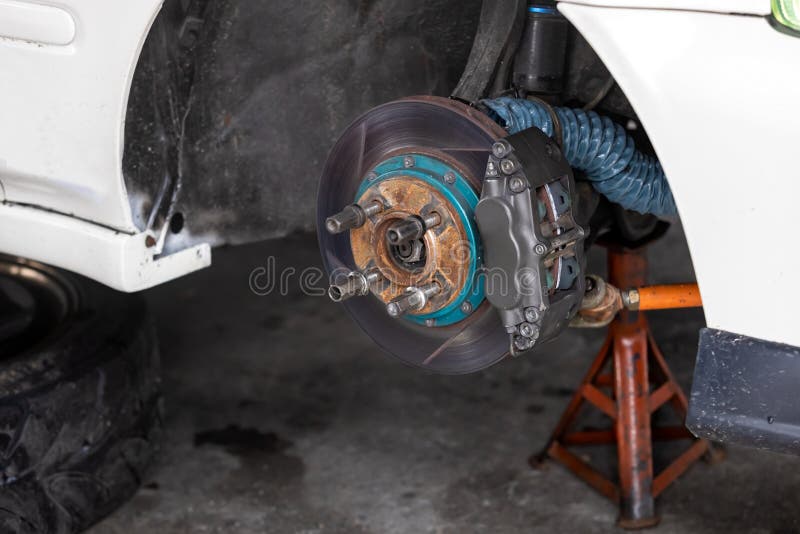 Maintenance Car. Jacking Up a Car for Changing Tire in Garage Stock Image Image of check