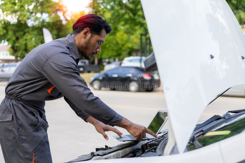 maintenance-concept-asian-auto-mechanic-or-smith-writing-on-clipboard