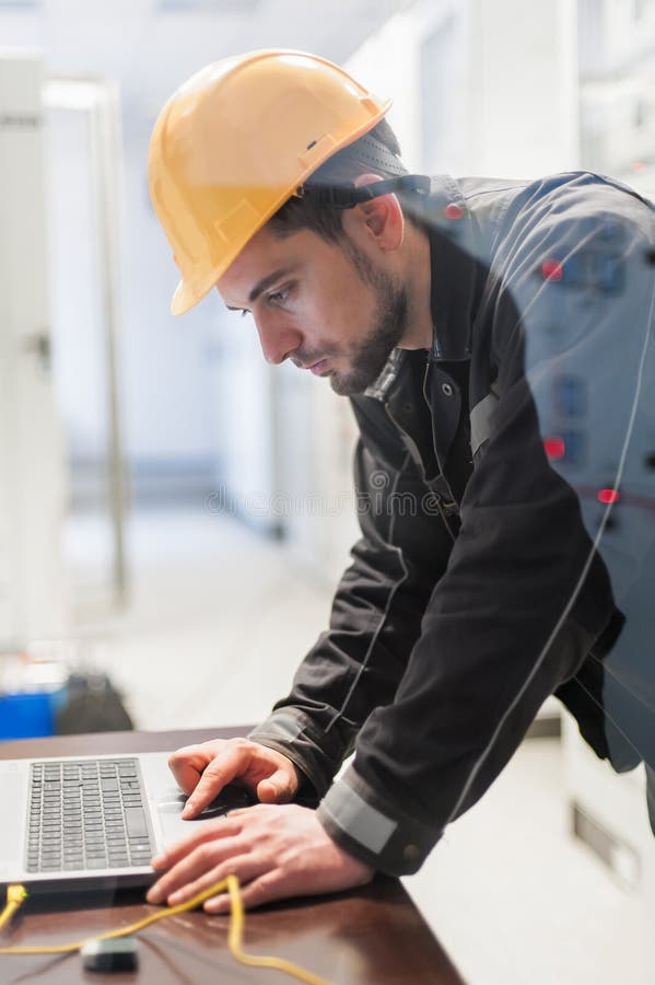 Maintenance engineer inspect relay protection system with laptop royalty free stock image