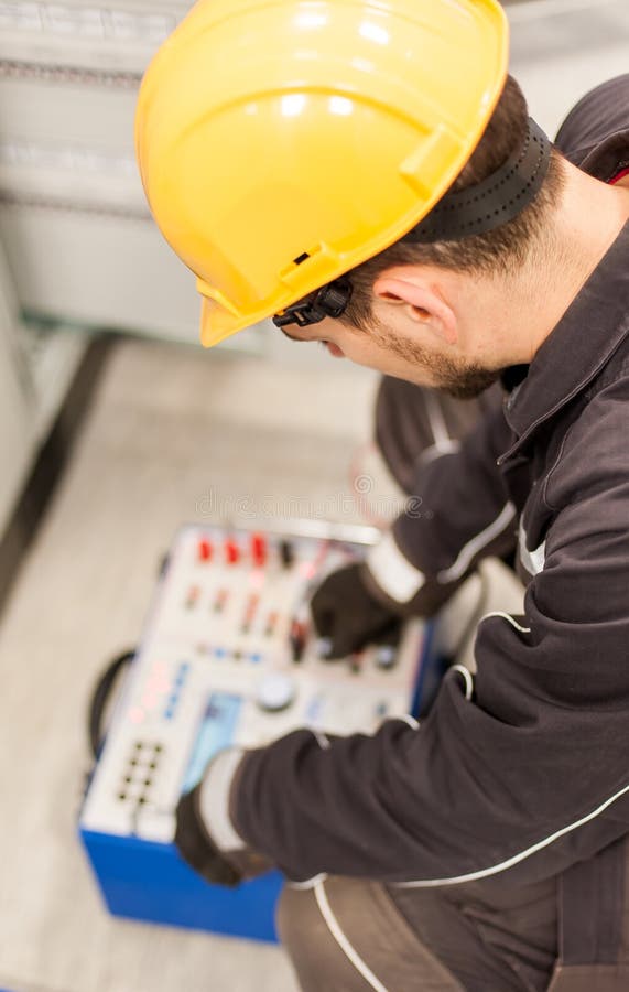 Maintenance engineer inspect system with relay test set equipment stock image