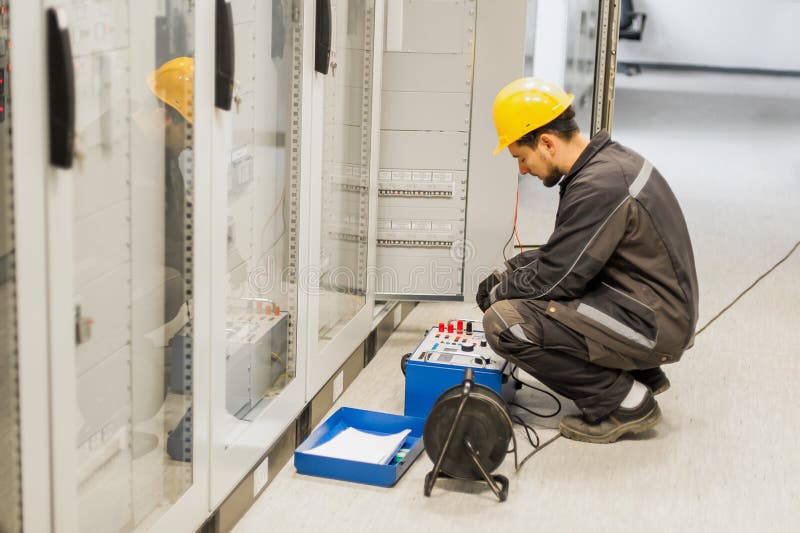 Maintenance engineer inspect system with relay test set equipment stock photos