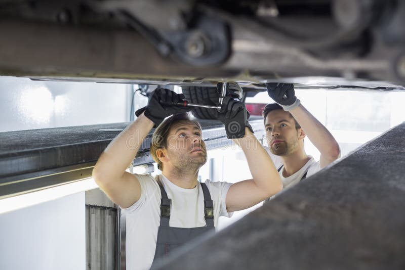 Maintenance Engineers Repairing Car in Stock Image Image of
