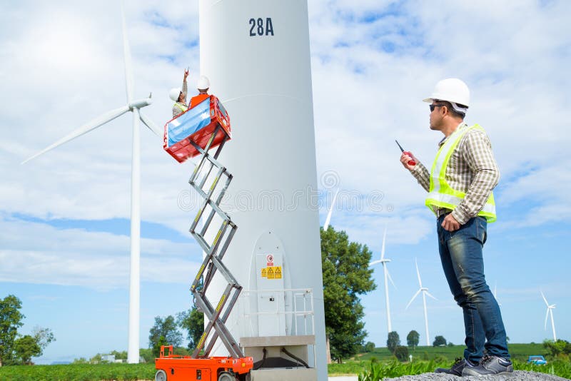 Maintenance engineers working at wind turbine power generator royalty free stock image