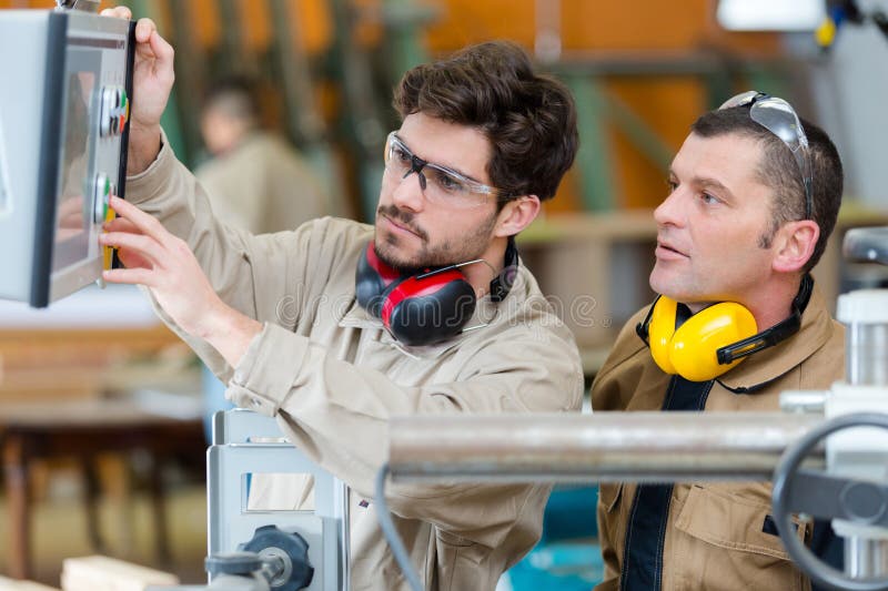 Maintenance Technicians Fix and Cleaning Machine in Factory Stock Photo