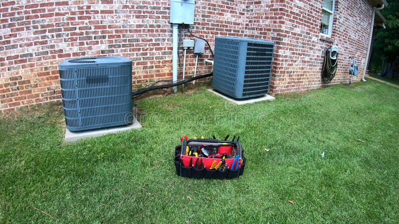 Maintenance tool bag in front of home HVAC Air Conditioner units