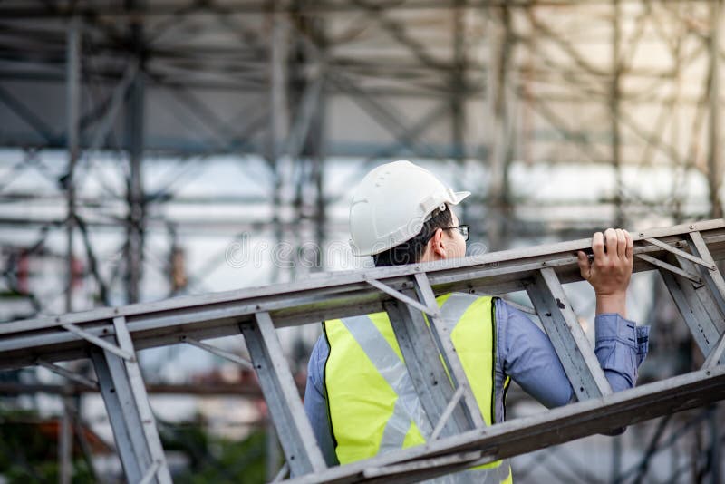 Maintenance worker man carrying aluminium ladder stock images Maintenance worker man carrying aluminium ladder stock images