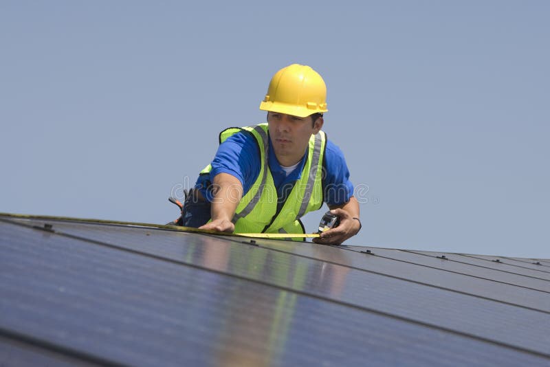 Maintenance Worker Measuring Solar Panels royalty free stock photo