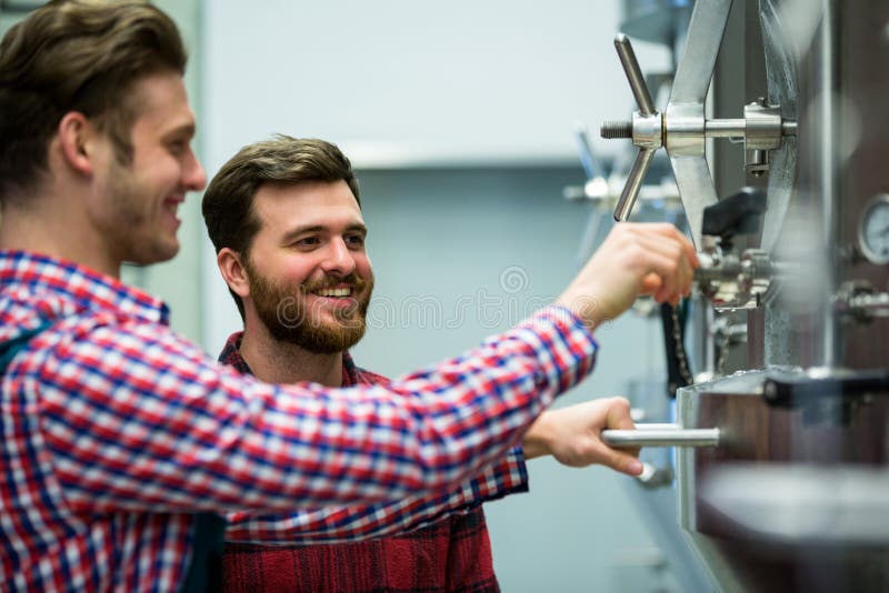 Maintenance Workers Examining Brewery Machine Stock Image Image of
