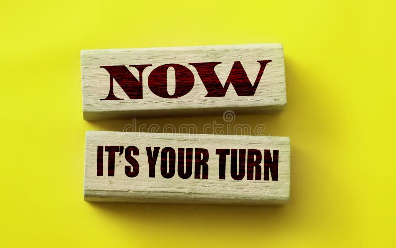 Wooden blocks form the words Now it`s your turn on yellow background. Business concept. Wooden blocks form the words Now it`s your turn on yellow background. Business concept.