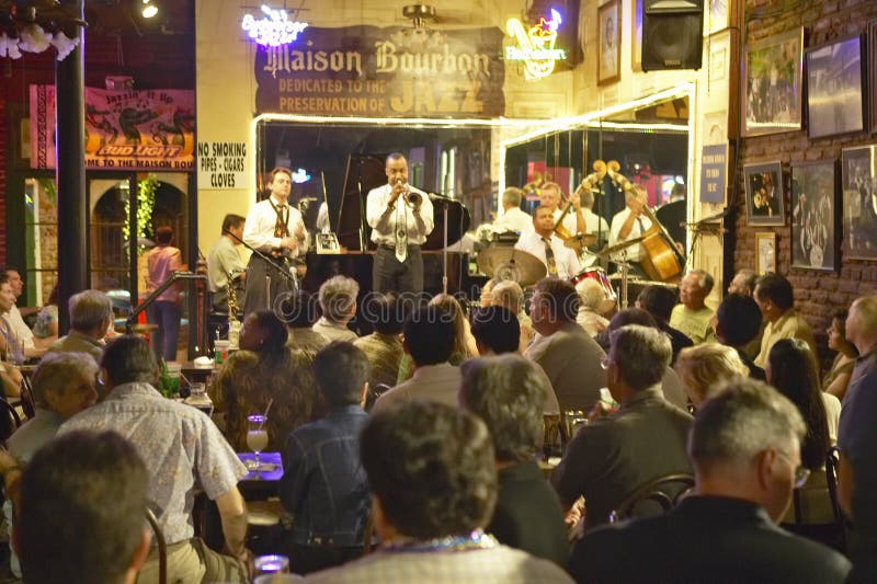 Maison Bourbon Jazz Club with Dixieland band and trumpet player performing at night in French Quarter in New Orleans, Louisiana. Maison Bourbon Jazz Club with Dixieland band and trumpet player performing at night in French Quarter in New Orleans, Louisiana