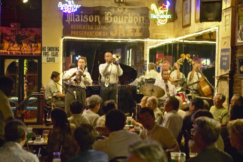 Maison Bourbon Jazz Club with Dixieland band and trumpet player performing at night in French Quarter in New Orleans, Louisiana. Maison Bourbon Jazz Club with Dixieland band and trumpet player performing at night in French Quarter in New Orleans, Louisiana