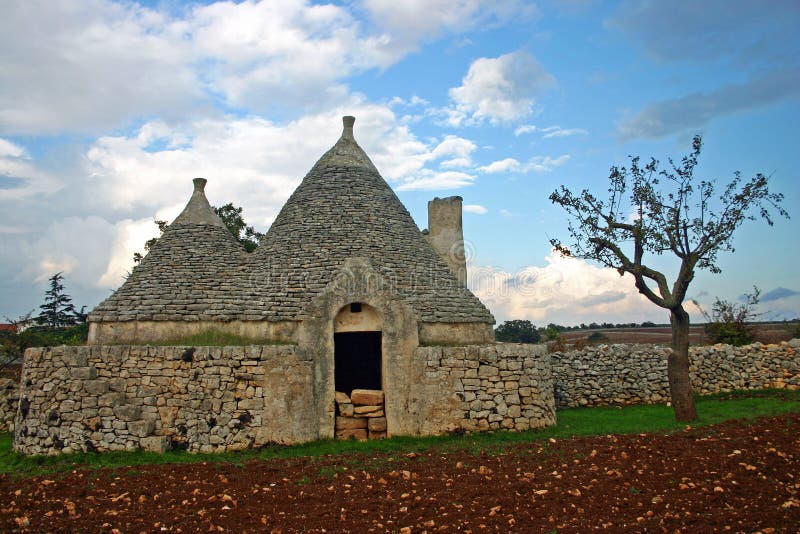 Trulli house assembled of rough stone on a field. Trulli house assembled of rough stone on a field