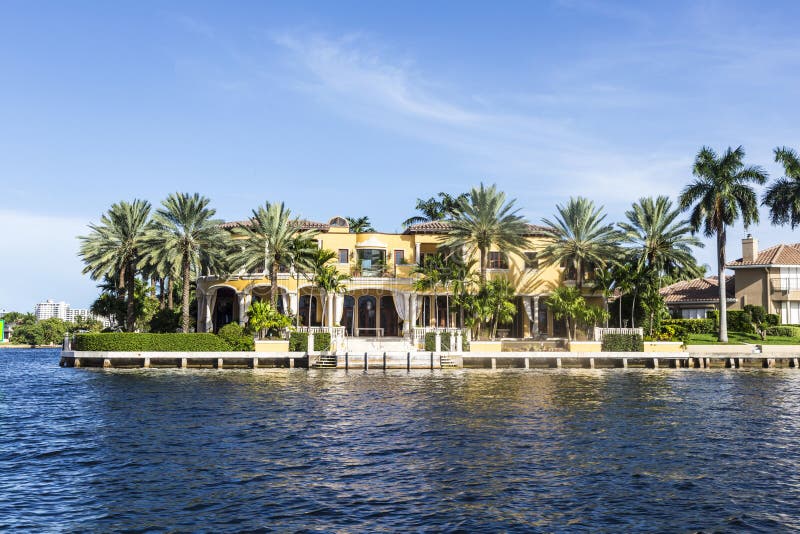 FORT LAUDERDALE, USA - AUG 20, 2014: Luxurious waterfront home in Fort Lauderdale, USA. There are 165 miles of waterways within the city limits and 9,8 percent of the city is covered by water. FORT LAUDERDALE, USA - AUG 20, 2014: Luxurious waterfront home in Fort Lauderdale, USA. There are 165 miles of waterways within the city limits and 9,8 percent of the city is covered by water.