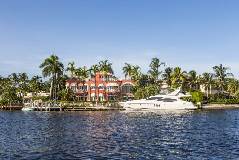 FORT LAUDERDALE, USA - AUG 20, 2014: Luxurious waterfront home in Fort Lauderdale, USA. There are 165 miles of waterways within the city limits and 9,8 percent of the city is covered by water. FORT LAUDERDALE, USA - AUG 20, 2014: Luxurious waterfront home in Fort Lauderdale, USA. There are 165 miles of waterways within the city limits and 9,8 percent of the city is covered by water.