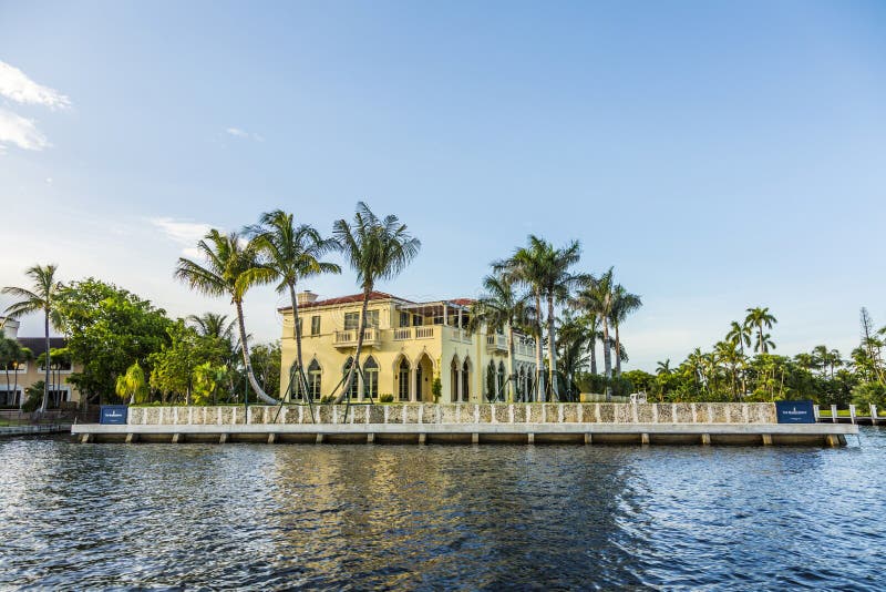 FORT LAUDERDALE, USA - AUG 20, 2014: Luxurious waterfront home in Fort Lauderdale, USA. There are 165 miles of waterways within the city limits and 9,8 percent of the city is covered by water. FORT LAUDERDALE, USA - AUG 20, 2014: Luxurious waterfront home in Fort Lauderdale, USA. There are 165 miles of waterways within the city limits and 9,8 percent of the city is covered by water.