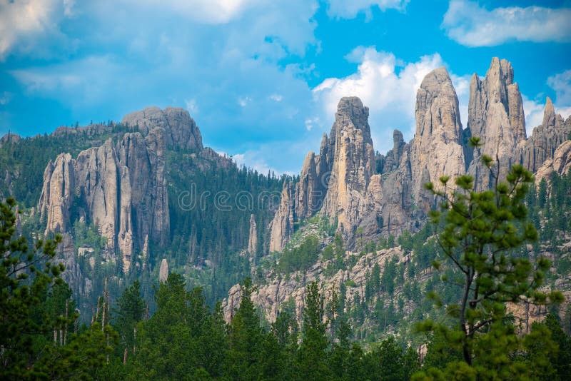 A majestic mountain range of Needles against a bright blue sky in the United States. A majestic mountain range of Needles against a bright blue sky in the United States