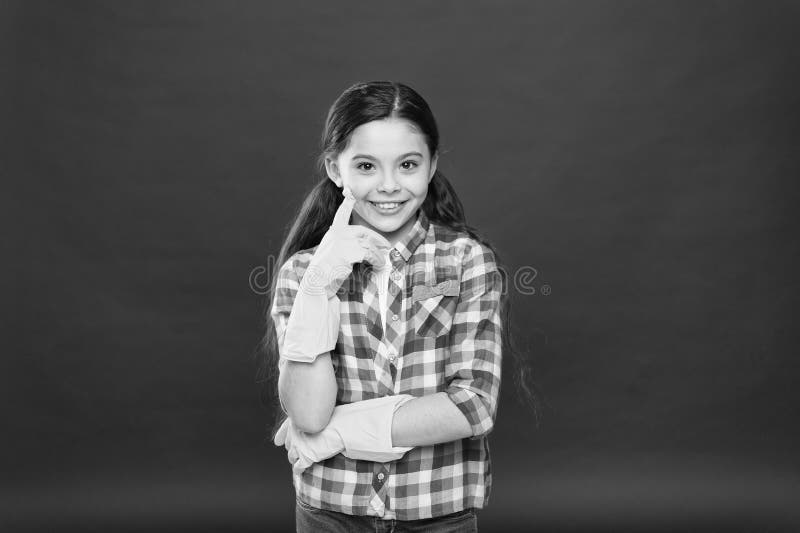 Make it in easy way. Spring cleaning. House cleaning service. Cleaning supplies. Small girl rubber gloves for cleaning. Red background. Appreciate cleanliness stock photography Make it in easy way. Spring cleaning. House cleaning service. Cleaning supplies. Small girl rubber gloves for cleaning. Red background. Appreciate cleanliness stock photography