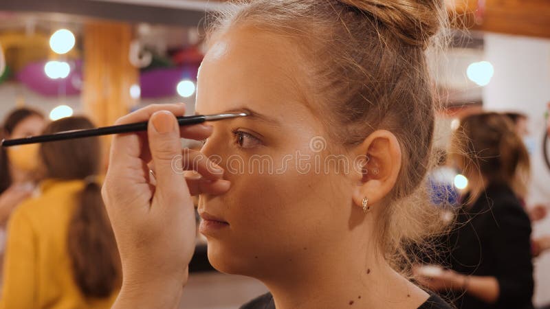 Make-up artist apply makeup with large brush - closeup