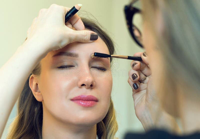 Makeup Artist Combing Eyebrow. Stock Photo Image of makeup, business 69160704