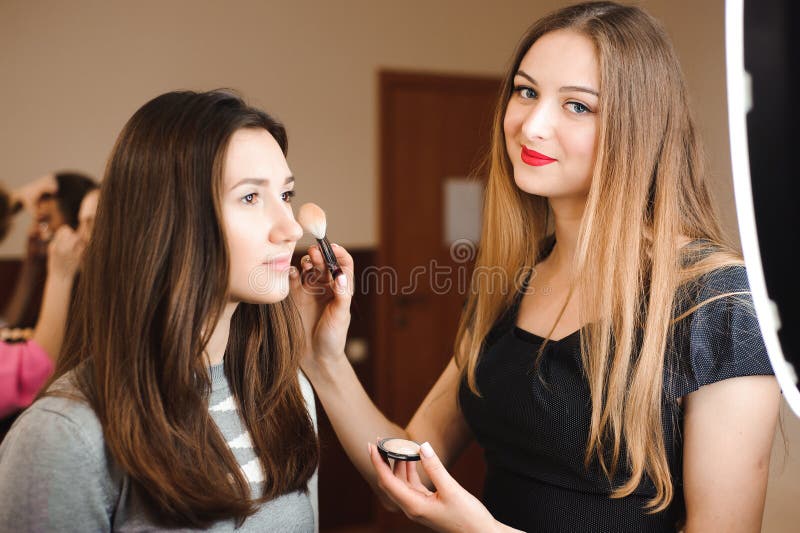 Make up artist doing professional make up of young woman. Beauty shcool. stock photo Make up artist doing professional make up of young woman. Beauty shcool. stock photo