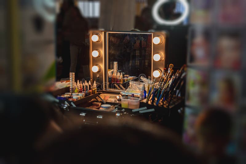 Make-up artist`s workstation with a mirror and lights for backlighting