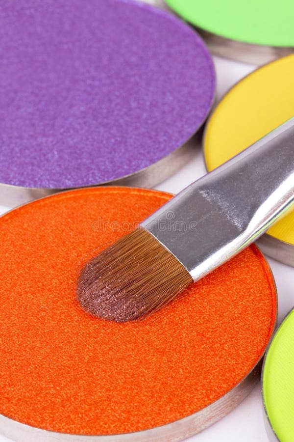 Make-up brush on orange eye shadows palette