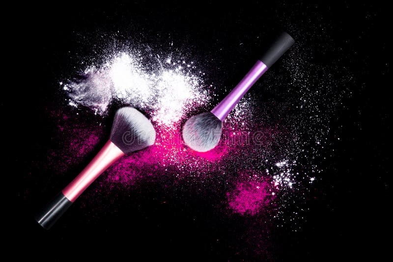 Make-up brush with white powder spilled glitter dust on black background. Makeup brush on new year`s Party with bright colors.