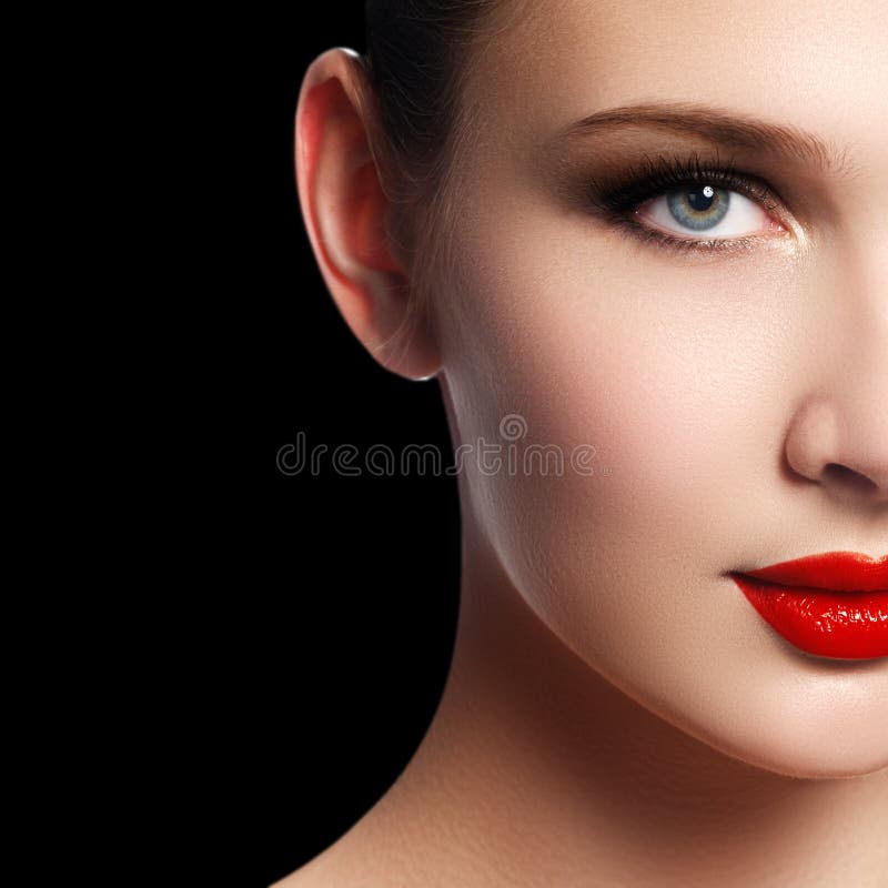 Make-up and cosmetics. Beauty woman face isolated on black background. Beautiful model girl makeup. Gorgeous lady with blue eyes