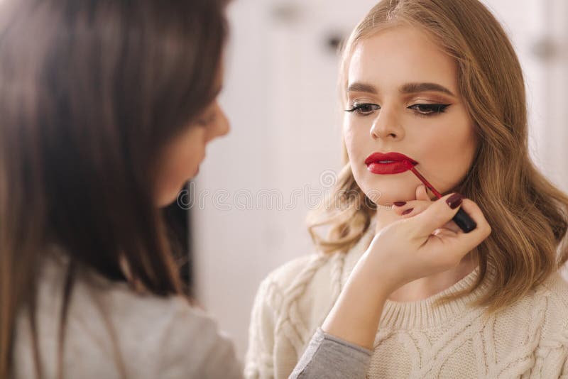 Makeup Artist Applies Red Lipstick. Hand of Make-up Master, Painting ...