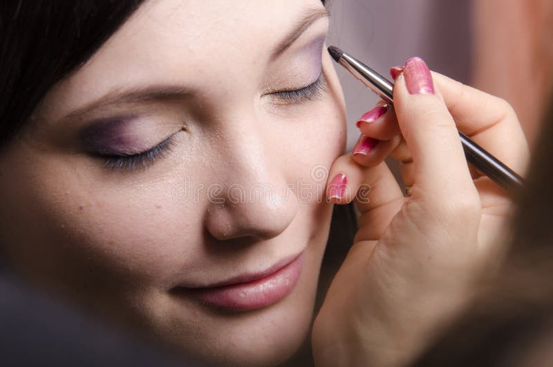 Makeup Artist in the Process of Makeup Colors Upper Eyelids Model Stock