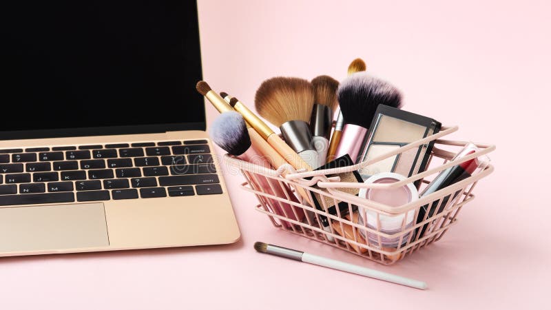 Makeup beauty online shopping business concept with cosmetic products in shopping basket on pastel pink background. Makeup beauty online shopping business concept with cosmetic products in shopping basket on pastel pink background