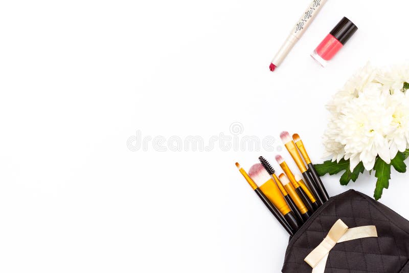 Makeup brush in the makeup, red lipstick, pink nail Polish and a chrysanthemum flower on a white background. Minimal feminine conc royalty free stock images Makeup brush in the makeup, red lipstick, pink nail Polish and a chrysanthemum flower on a white background. Minimal feminine conc royalty free stock images