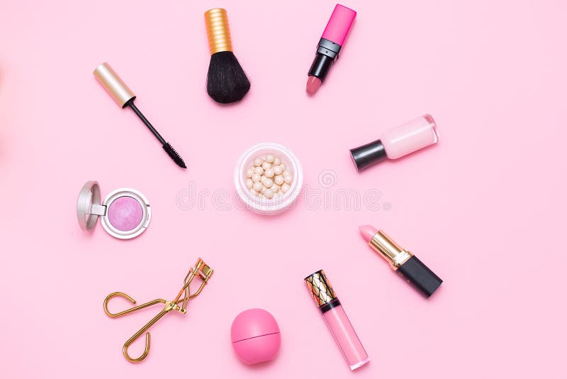 Pink cosmetics vertical flat lay with brush