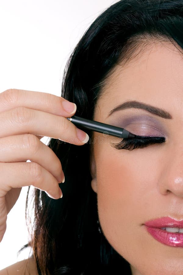 Woman applying makeup - closeup. Woman applying makeup - closeup