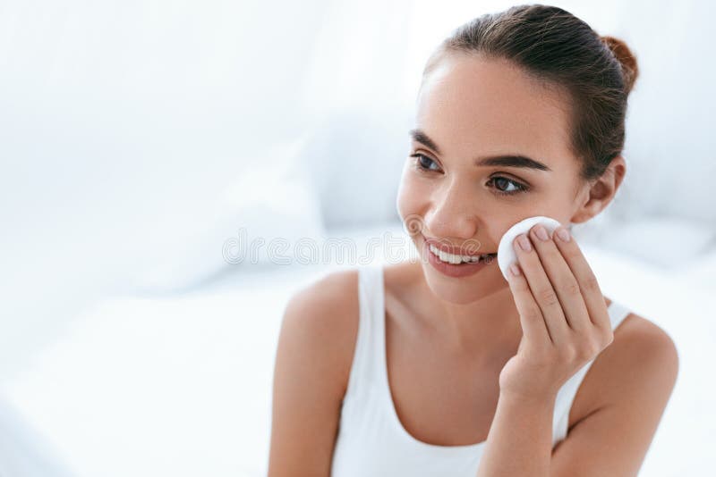 Makeup Remove. Girl Cleaning Face Skin With Cosmetic Pad royalty free stock image Makeup Remove. Girl Cleaning Face Skin With Cosmetic Pad royalty free stock image