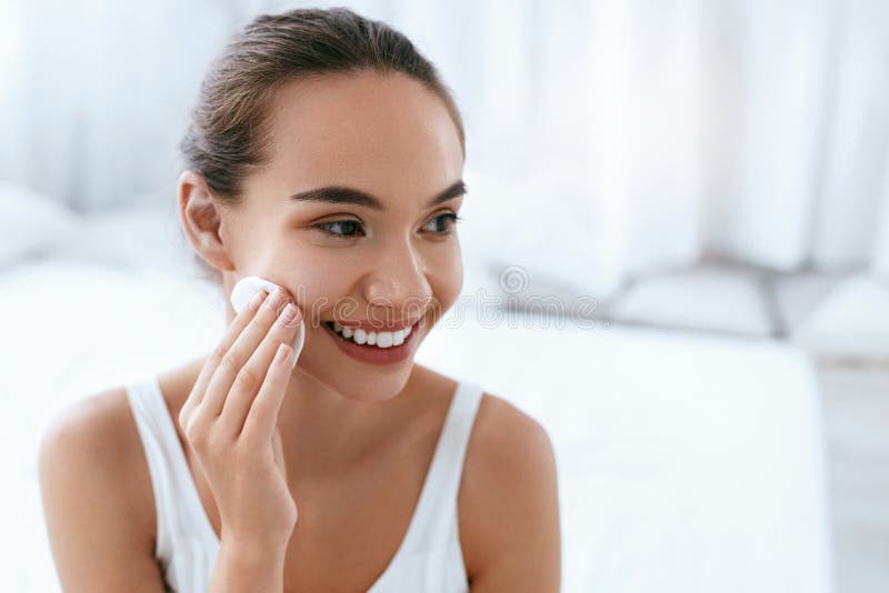 Makeup Remove. Girl Cleaning Face Skin With Cosmetic Pad stock photography Makeup Remove. Girl Cleaning Face Skin With Cosmetic Pad stock photography