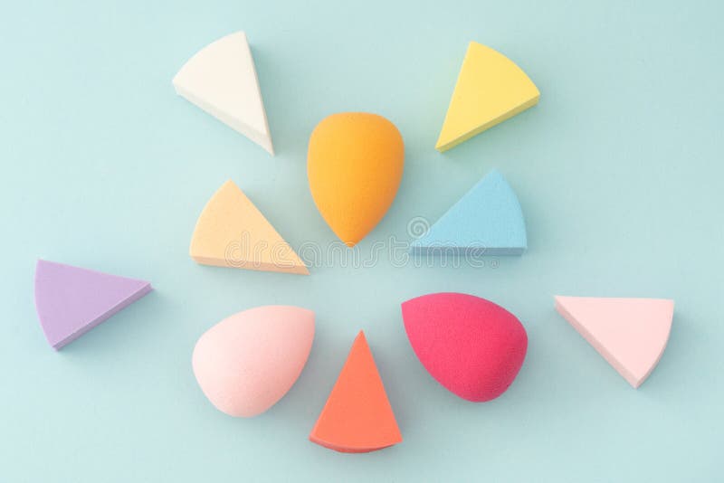 Makeup Sponges Triangular and Round Shapes on a Blue Background Stock