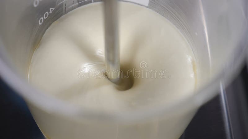 Making body and face care production. Lab technician chemist cosmetician mixing cosmetic ingredients in glass tube in