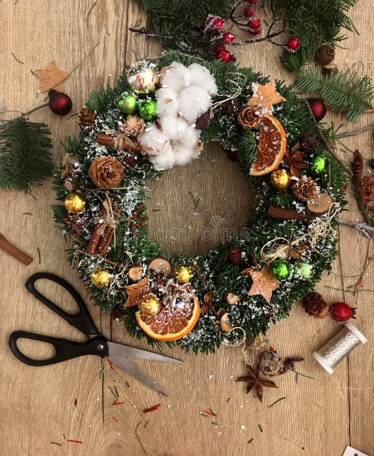 Making of Christmas Wreath. Christmas Wreath on Wooden Table Top View