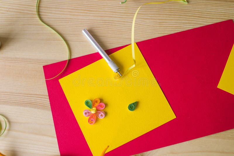 Making compositions from long and narrow strips of paper twisted into spirals stock photo