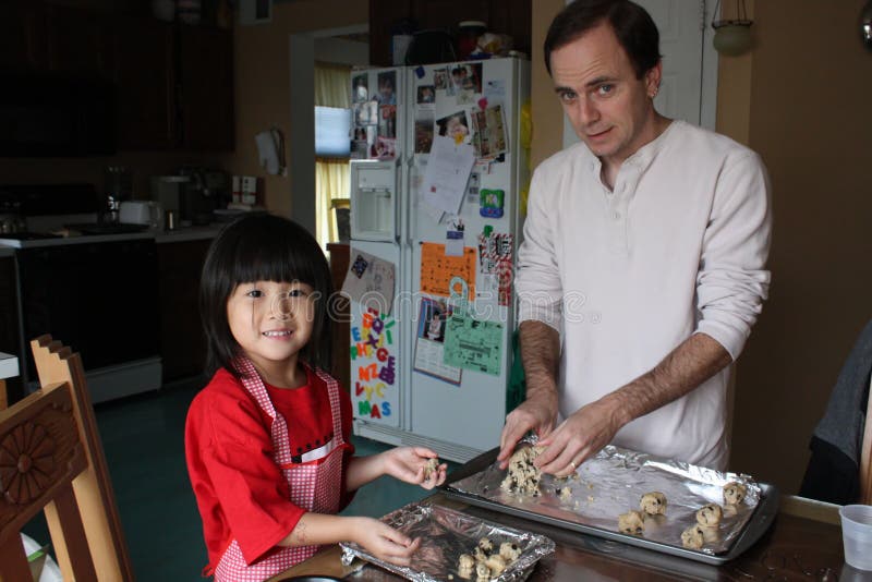 daughter and dad make cookies