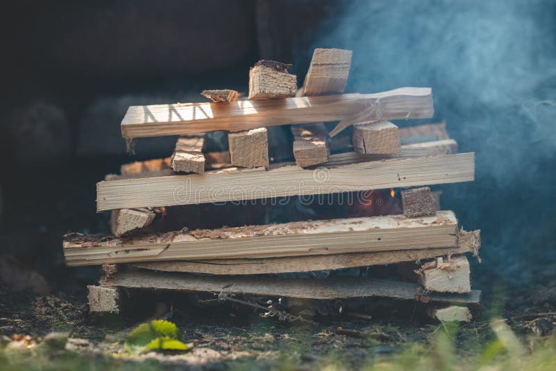 Making a Fire Using Paper and Small Wood Chips Stacked in Pyramid