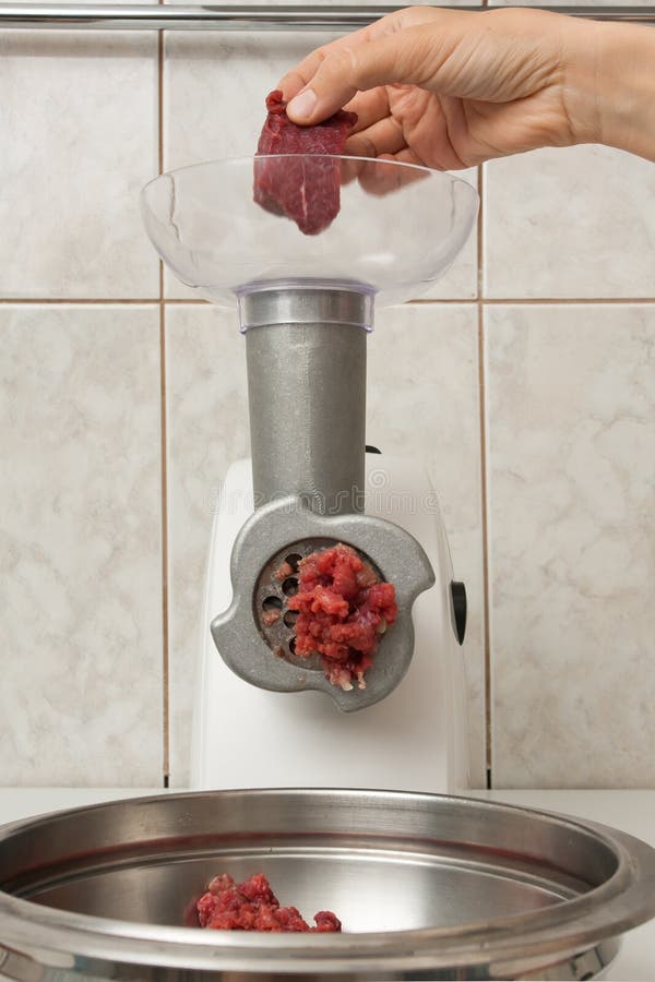 Making forcemeat with meat grinder royalty free stock photography Making forcemeat with meat grinder royalty free stock photography