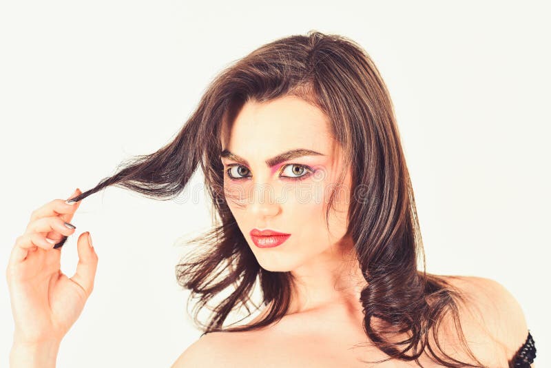 Making my hair look fabulous. Pretty woman wear long and wavy hair. Sexy woman with perfect makeup. Makeup model with royalty free stock image Making my hair look fabulous. Pretty woman wear long and wavy hair. Sexy woman with perfect makeup. Makeup model with royalty free stock image